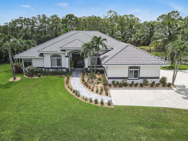 mediterranean / spanish-style house featuring a front yard