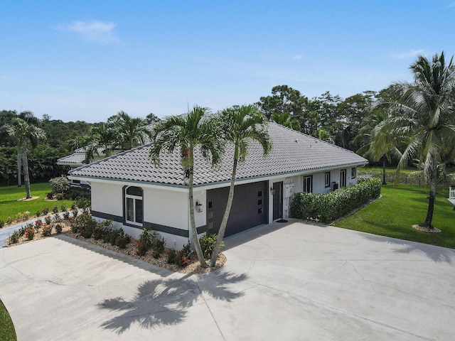 view of front of house with a front yard and a garage