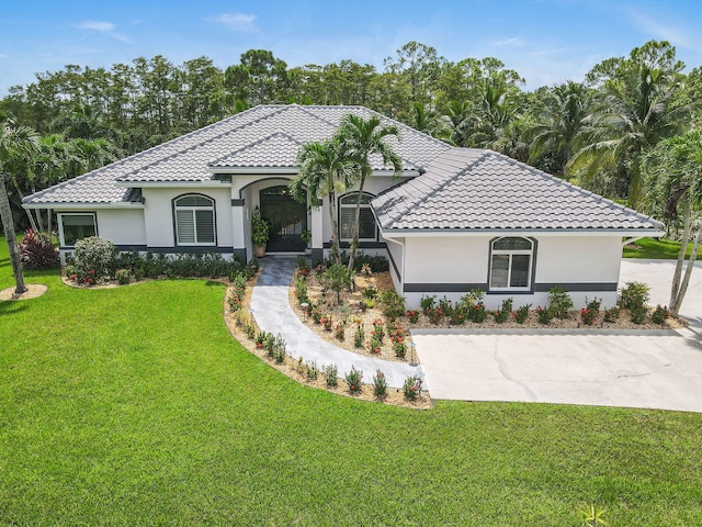 mediterranean / spanish-style home featuring a front lawn