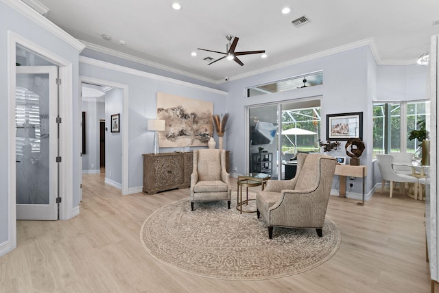 sitting room with ceiling fan, ornamental molding, and light hardwood / wood-style flooring