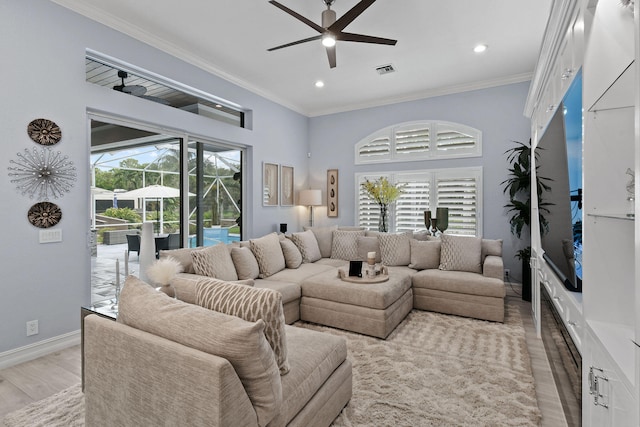 living room with ceiling fan, ornamental molding, and light hardwood / wood-style floors