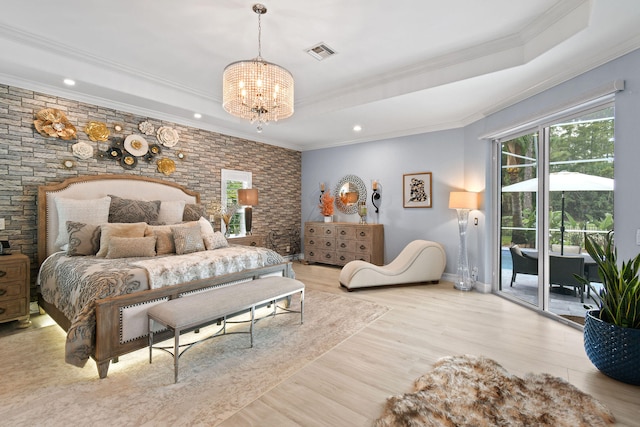 bedroom featuring light wood-type flooring, a notable chandelier, ornamental molding, access to outside, and a raised ceiling