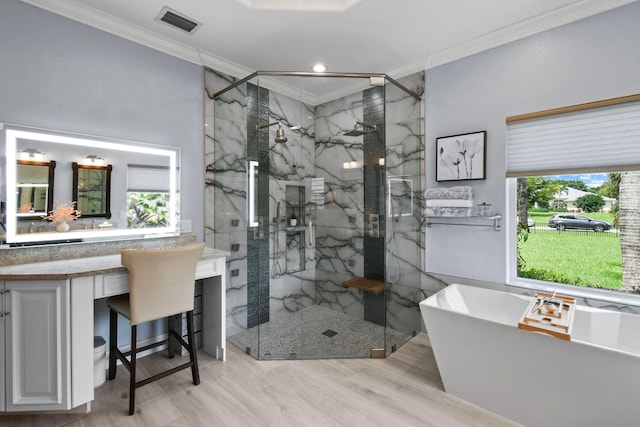 bathroom with vanity, ornamental molding, independent shower and bath, and hardwood / wood-style flooring