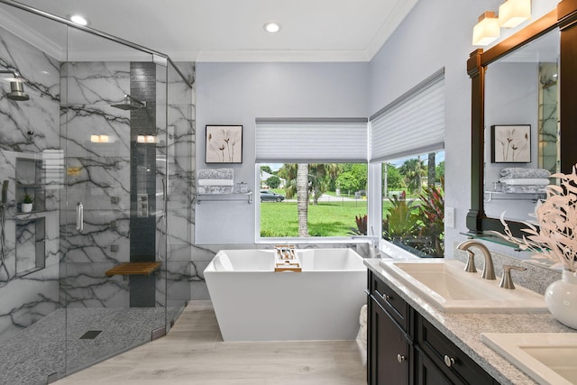 bathroom featuring ornamental molding, vanity, hardwood / wood-style flooring, and independent shower and bath