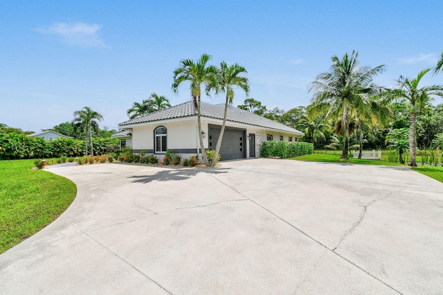 view of front of property featuring a garage and a front lawn