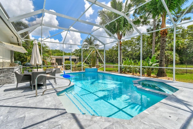 view of pool with glass enclosure, an in ground hot tub, and a patio