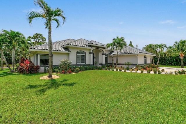 mediterranean / spanish house featuring a front yard