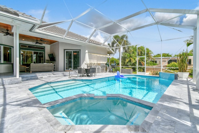 view of swimming pool with a lanai, outdoor lounge area, ceiling fan, and a patio area