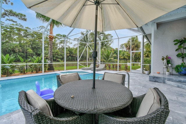 view of swimming pool featuring a lanai and a patio