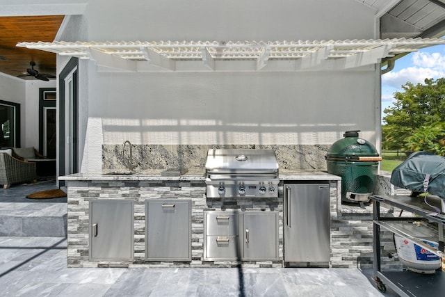 view of patio / terrace with a grill, ceiling fan, sink, and area for grilling