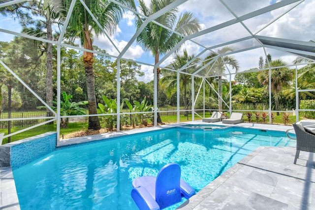 view of swimming pool featuring glass enclosure and a patio