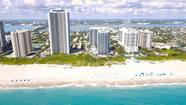 bird's eye view featuring a water view and a beach view