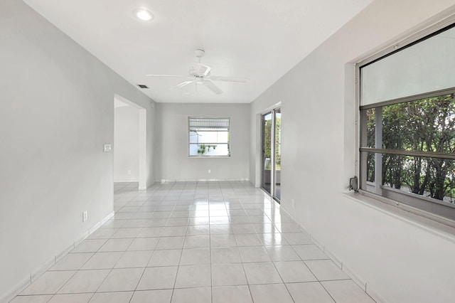 tiled spare room featuring ceiling fan