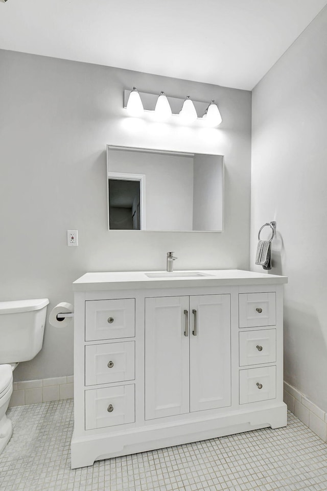 bathroom with tile patterned floors, vanity, and toilet