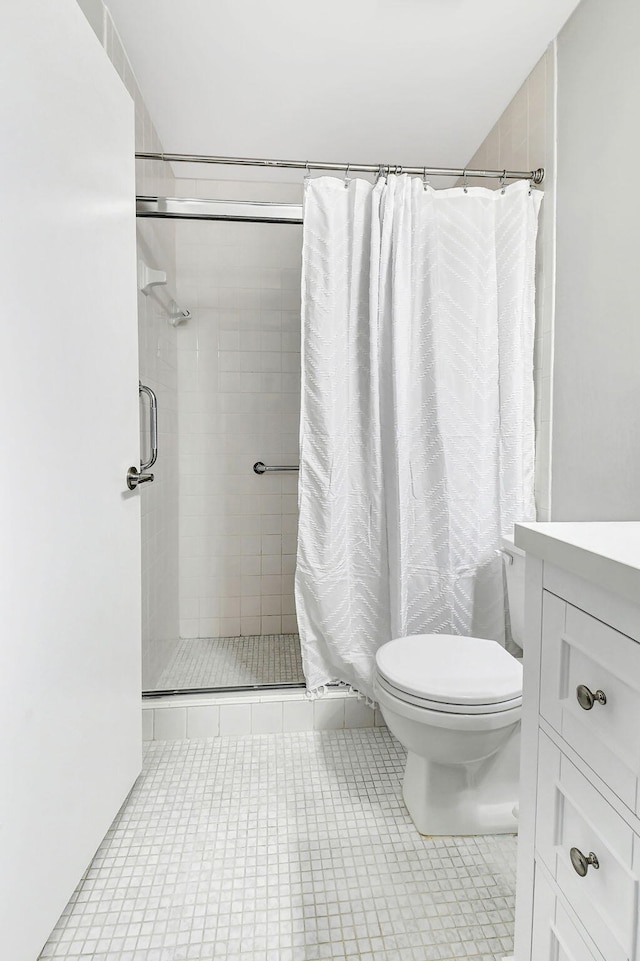 bathroom with tile patterned floors, vanity, toilet, and a shower with curtain