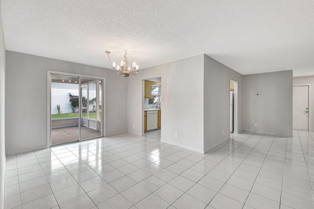 empty room featuring light tile patterned flooring, a textured ceiling, and a chandelier