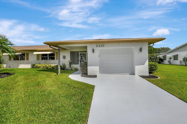 view of front facade with a garage and a front lawn