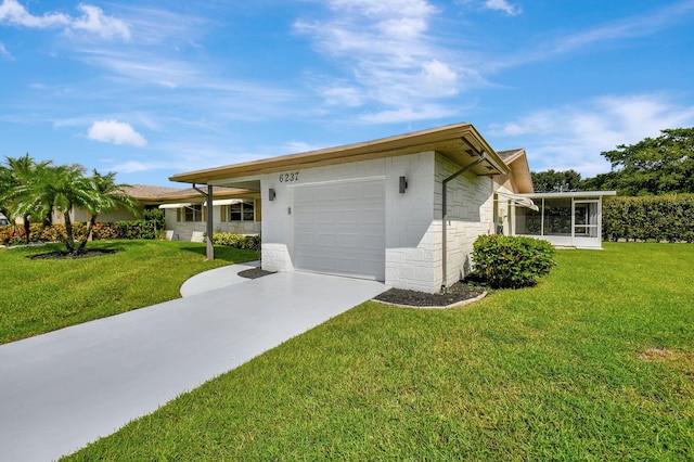 view of front of property with a front yard, a garage, and a sunroom