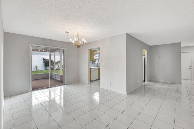 unfurnished room with a chandelier, light tile patterned floors, and a textured ceiling