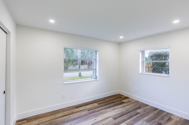 spare room with plenty of natural light and light hardwood / wood-style floors