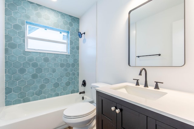 full bathroom featuring toilet, tiled shower / bath combo, and vanity