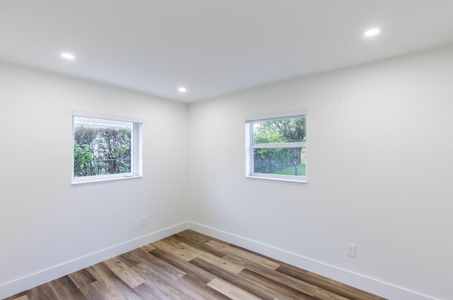 spare room with hardwood / wood-style flooring and a wealth of natural light