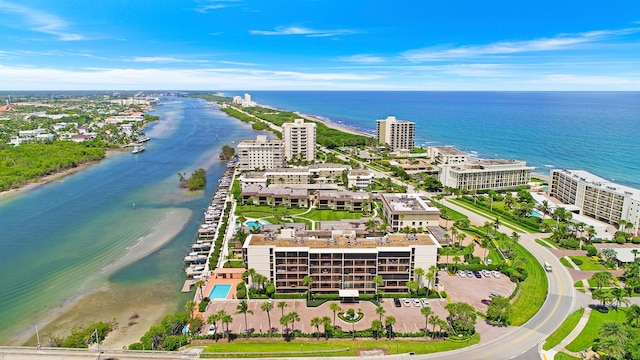 bird's eye view featuring a water view and a beach view