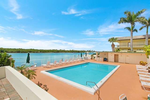 view of swimming pool with a water view