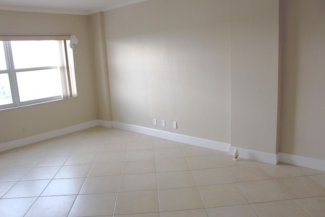 tiled spare room with crown molding