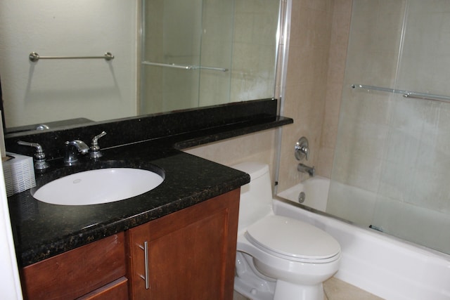 full bathroom featuring tiled shower / bath combo, vanity, and toilet