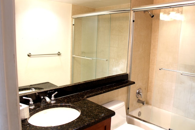 full bathroom with vanity, toilet, and bath / shower combo with glass door