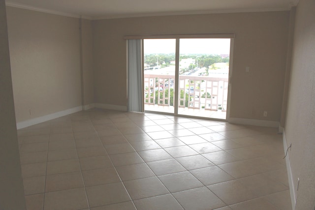 empty room featuring light tile patterned floors and ornamental molding