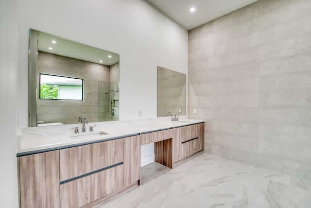 bathroom featuring vanity, a shower, and tile walls