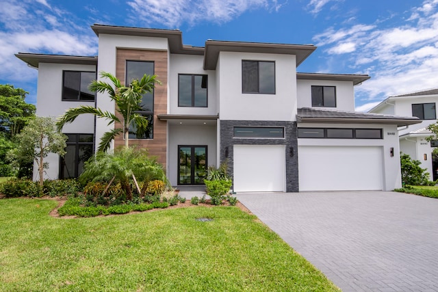 view of front of property featuring a front lawn and a garage