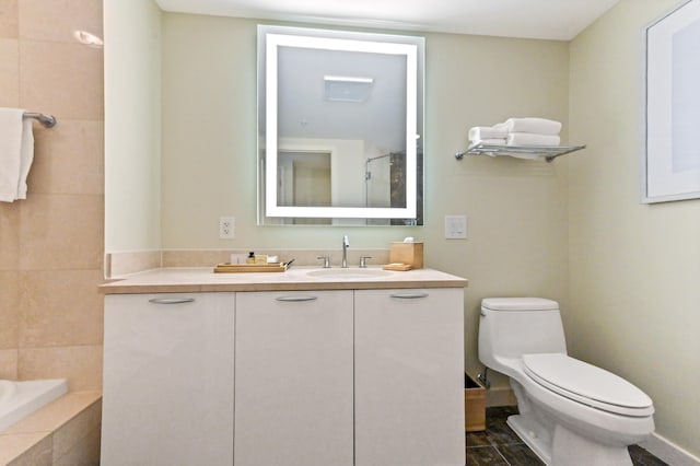 bathroom featuring tile patterned flooring, vanity, toilet, and walk in shower