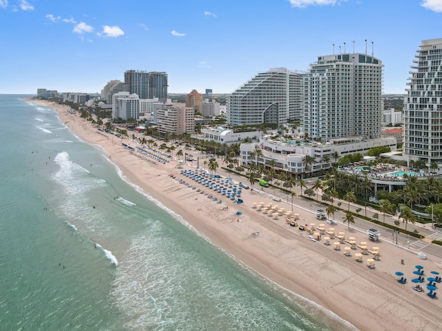 bird's eye view featuring a water view and a beach view