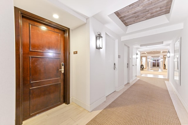 hallway with a raised ceiling