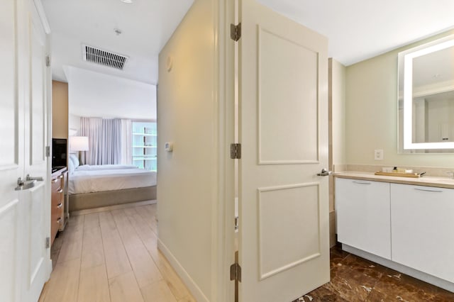 bathroom featuring vanity and hardwood / wood-style flooring