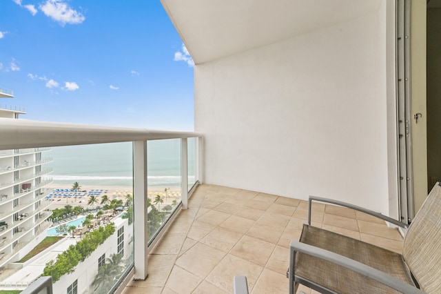 balcony with a beach view and a water view