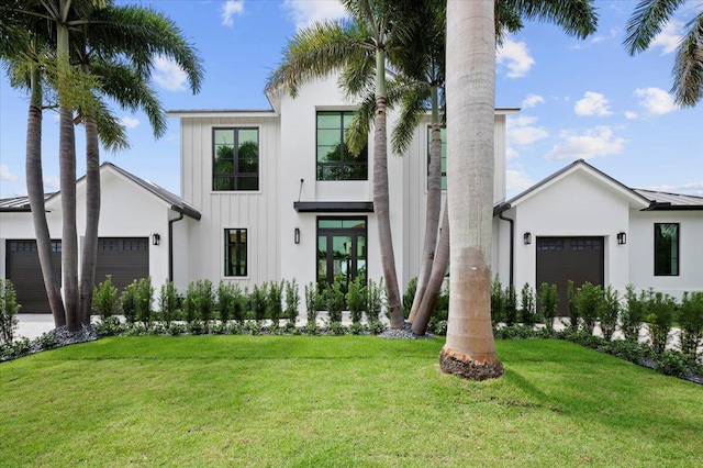 view of front of property featuring a front lawn and a garage