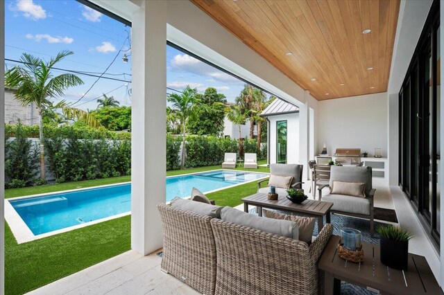 224 Edmor Rd, West Palm Beach, FL 33405 - view of pool with area for grilling, outdoor lounge area, a pool with connected hot tub, and a patio