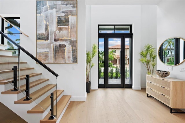224 Edmor Rd, West Palm Beach, FL 33405 - foyer entrance featuring light wood-type flooring, baseboards, and stairway