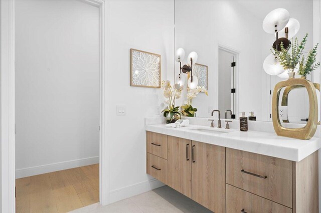 224 Edmor Rd, West Palm Beach, FL 33405 - bathroom with vanity, baseboards, and wood finished floors
