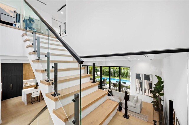 224 Edmor Rd, West Palm Beach, FL 33405 - stairway with wood finished floors, a towering ceiling, and recessed lighting