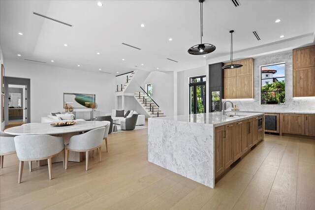224 Edmor Rd, West Palm Beach, FL 33405 - kitchen featuring a large island with sink, a sink, recessed lighting, light wood-style flooring, and tasteful backsplash