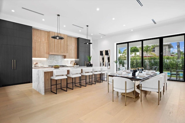 dining space with light wood-type flooring