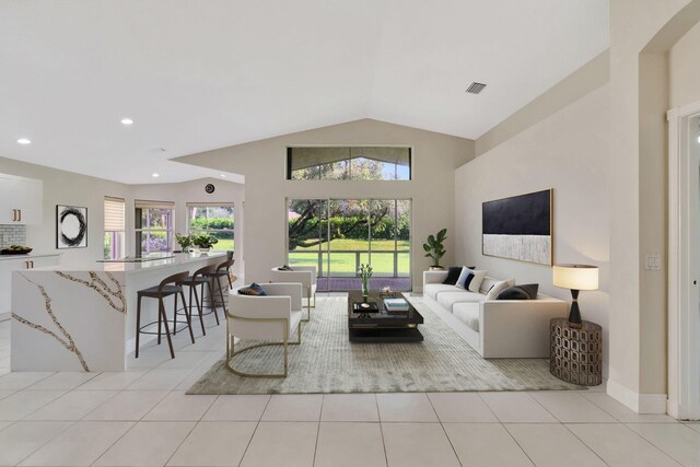 living room featuring light tile patterned floors and lofted ceiling