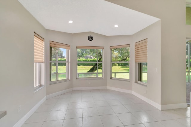 empty room with recessed lighting, baseboards, and light tile patterned flooring