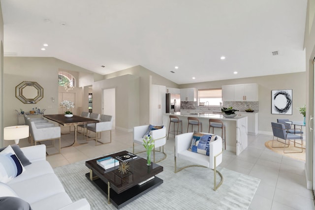 tiled living room featuring vaulted ceiling