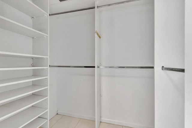 spacious closet featuring light tile patterned flooring